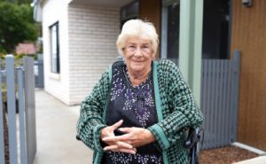 YourPlace Housing Tenant very happy out the front of her new home.